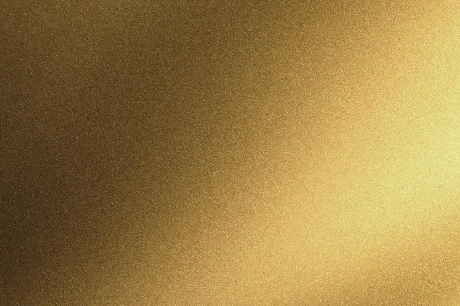 Abstract texture background, light shining on gold metallic wall in dark room photo