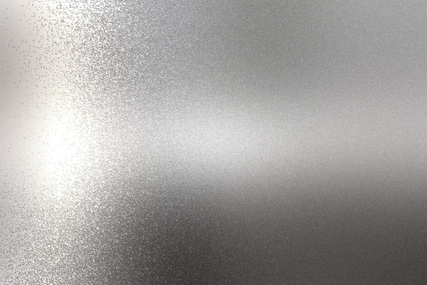 Light shining on rough chrome metal wall texture, abstract background photo