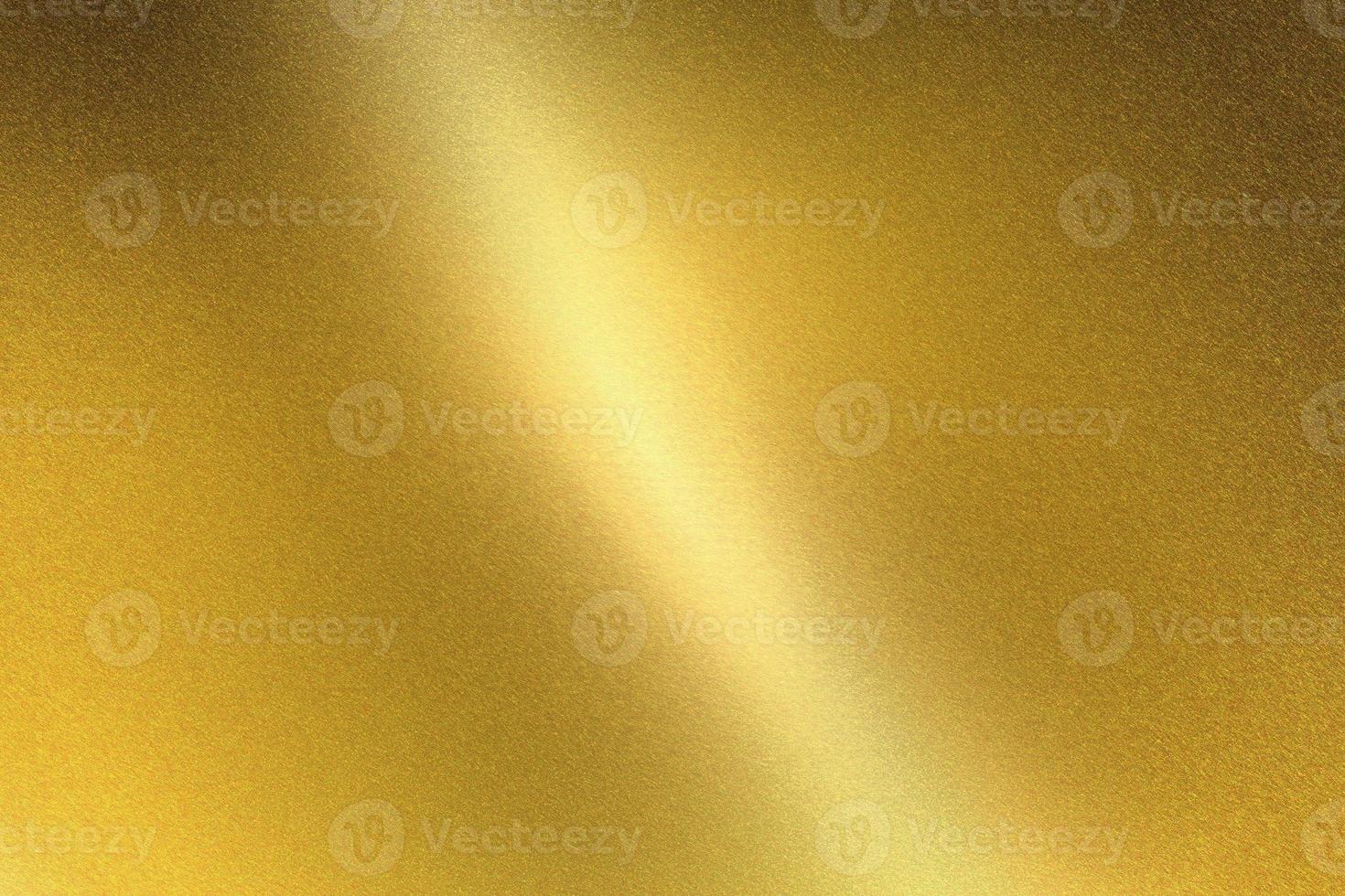 Light shining on gold metal sheet, abstract texture background photo