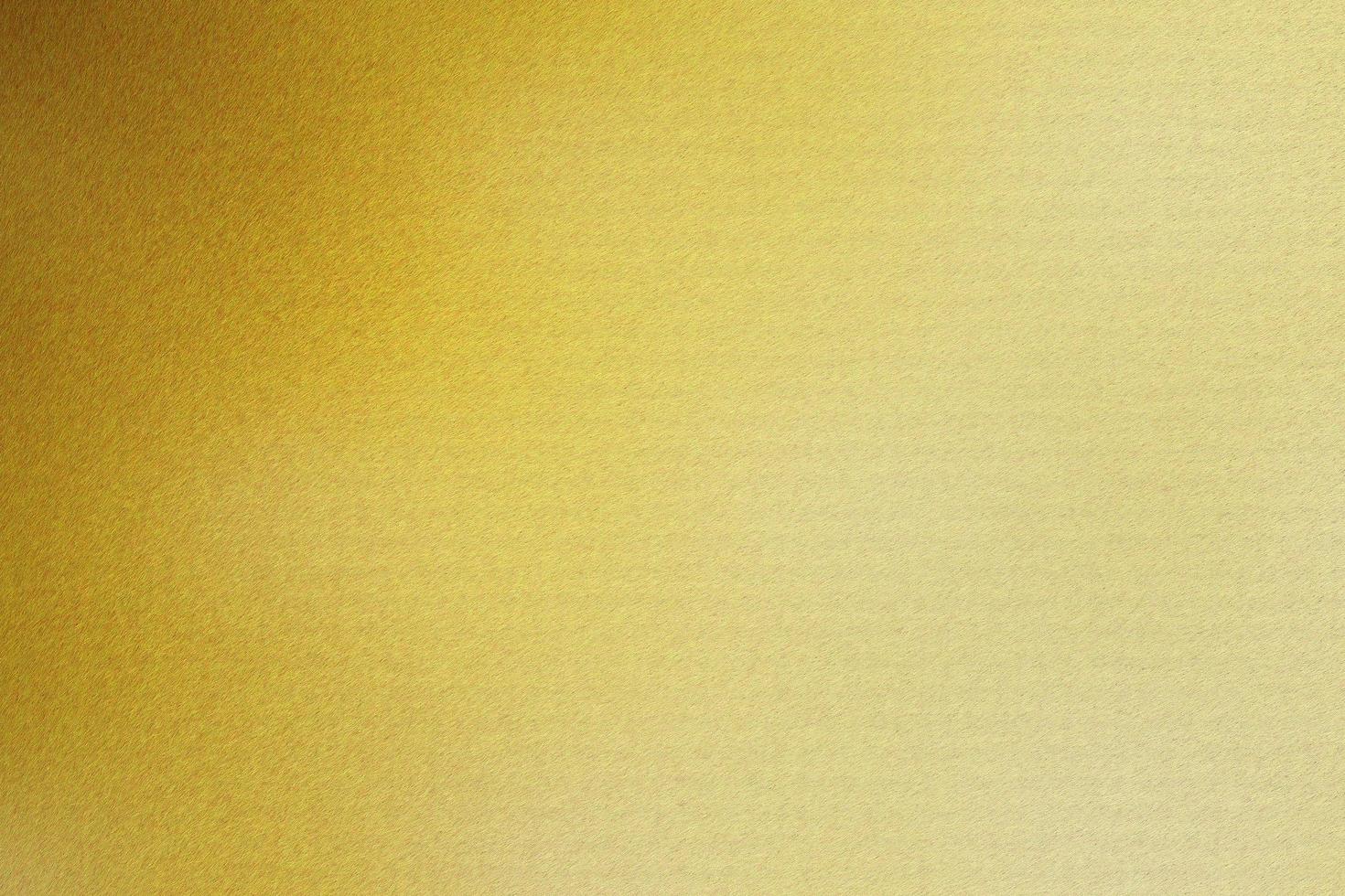 Brushed gold metallic wall with scratched surface, abstract texture background photo