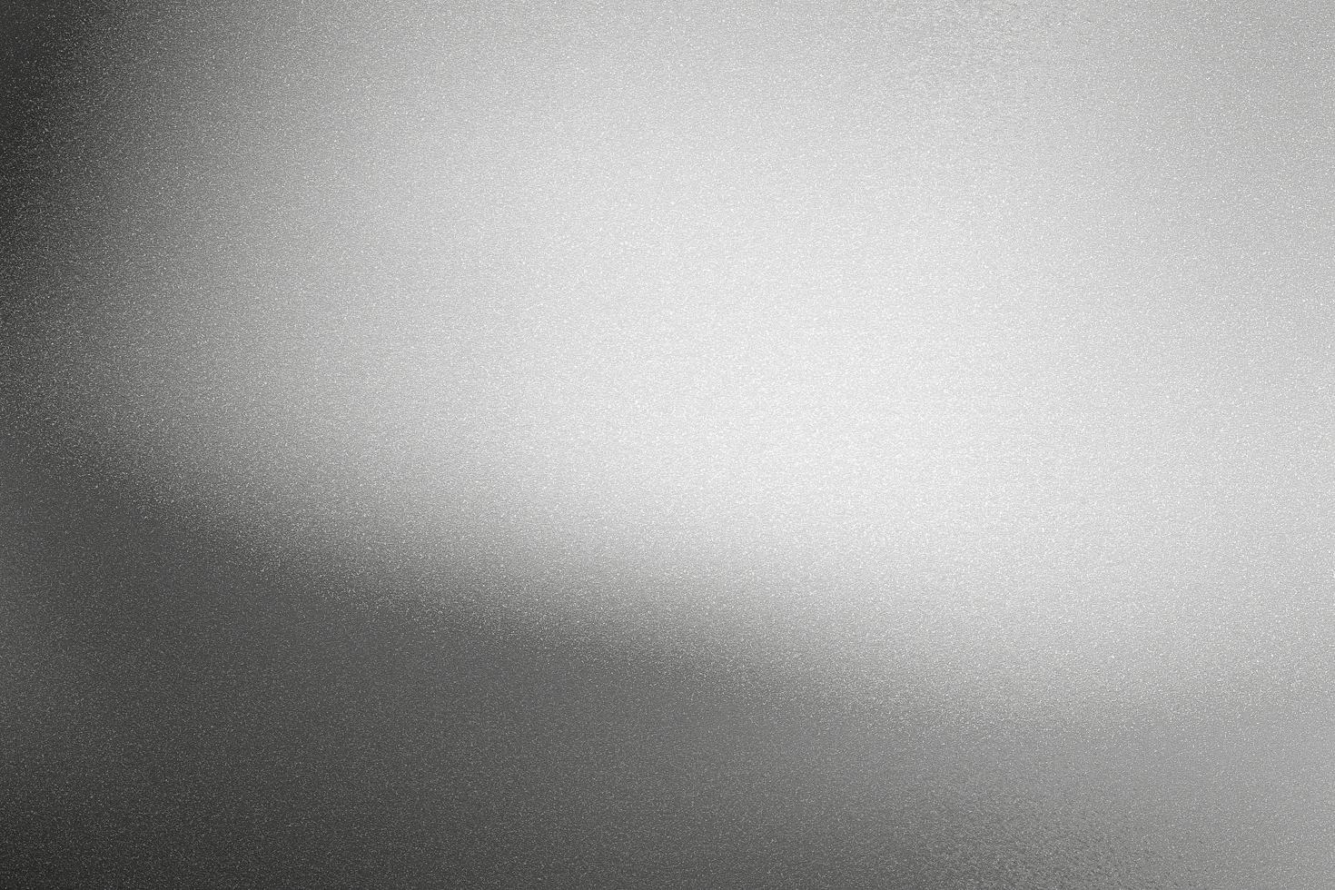 Glowing black silver foil metal wall with copy space, abstract texture background photo