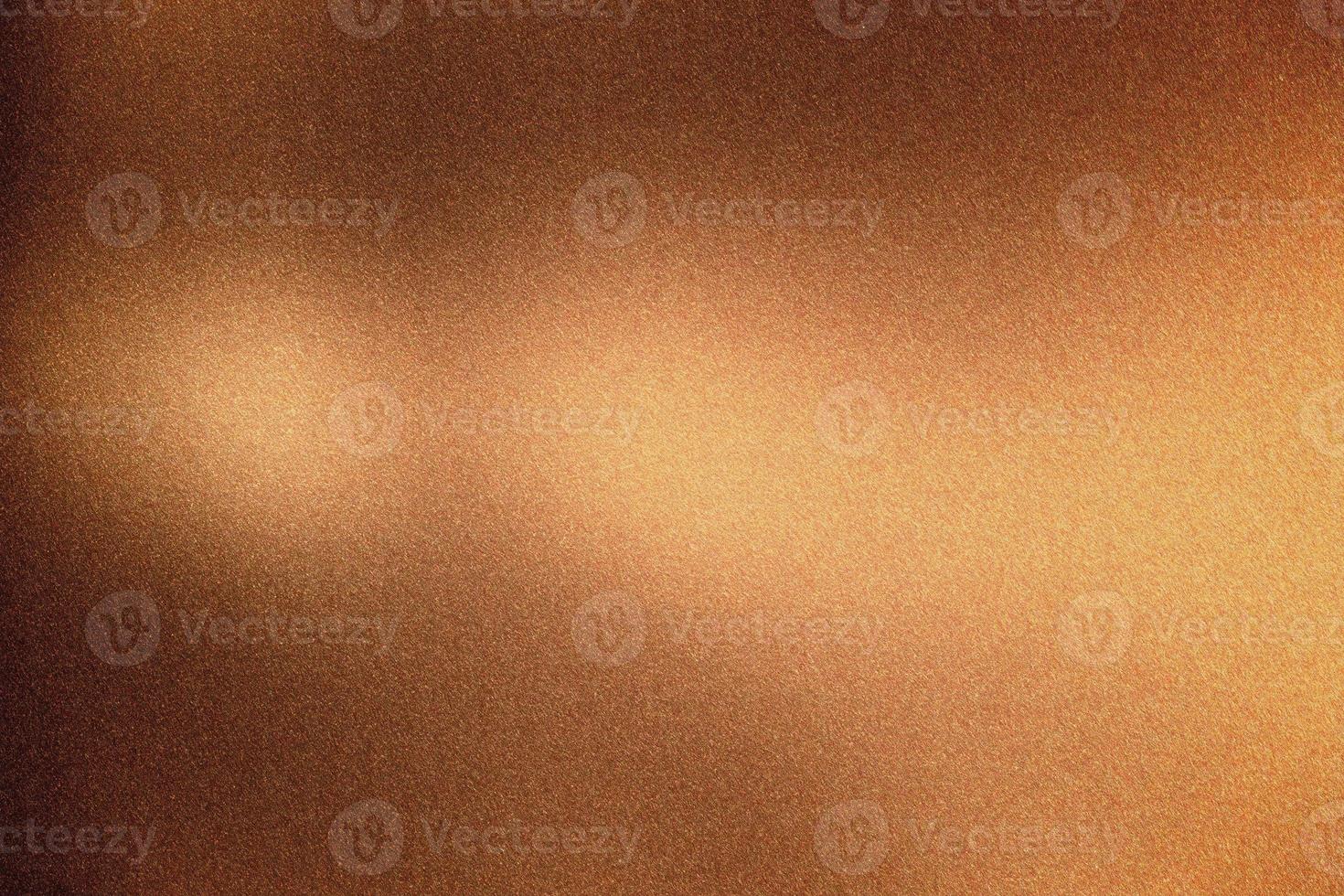 Glowing bronze rough metal wall, abstract texture background photo