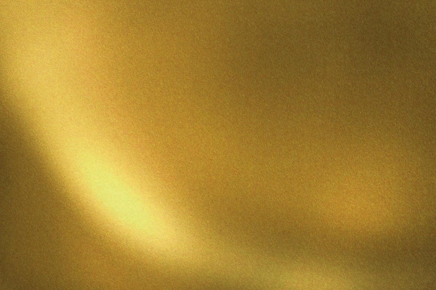 Light shining on gold brushed metal wall, abstract texture background photo
