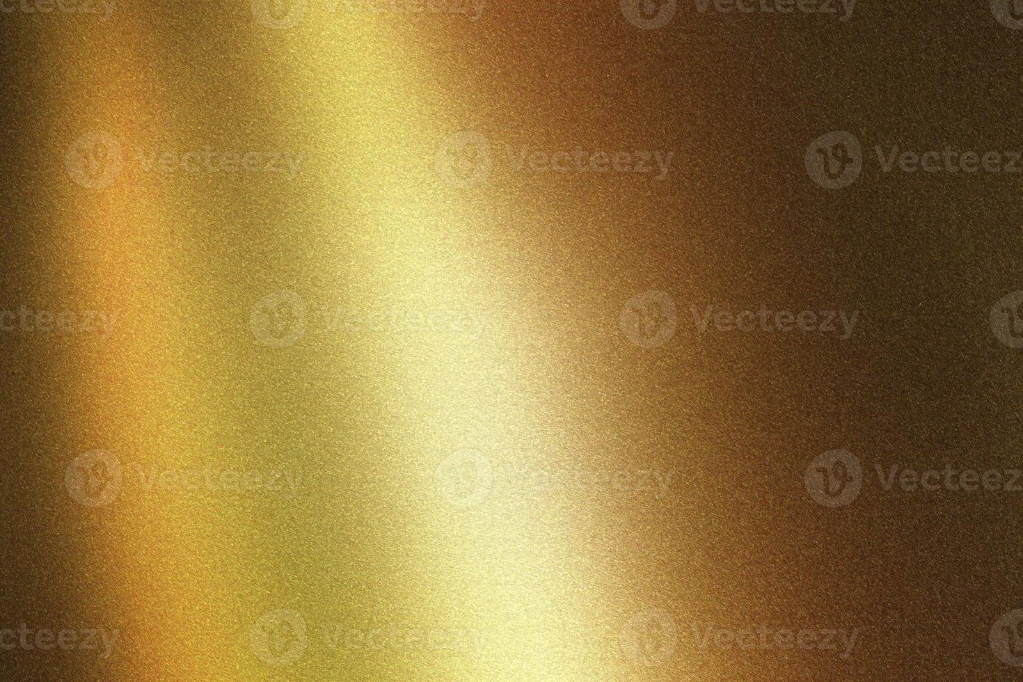 Light shining on bronze metallic wall in dark room, abstract texture background photo