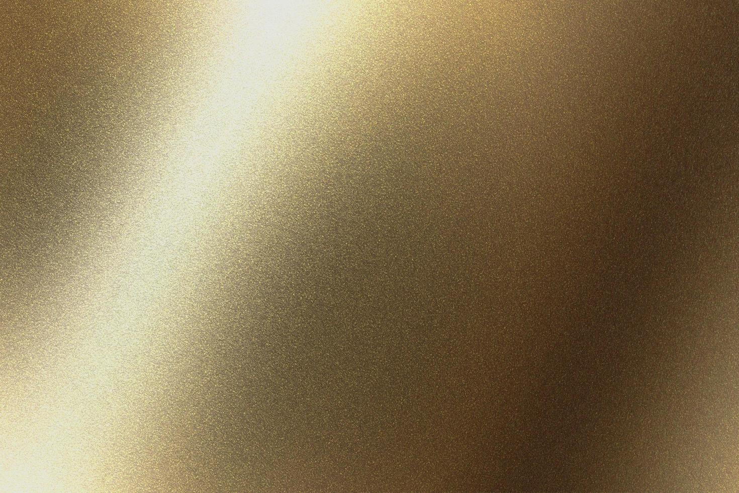 Abstract texture background, light shining on golden metal in dark room photo