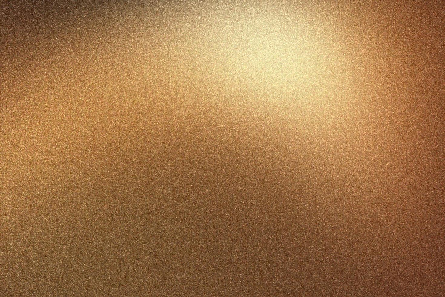 Glowing brushed bronze metal wall, abstract texture background photo