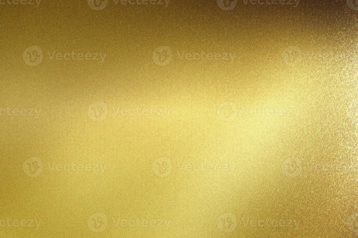 Glowing polished golden metal wall, abstract texture background photo