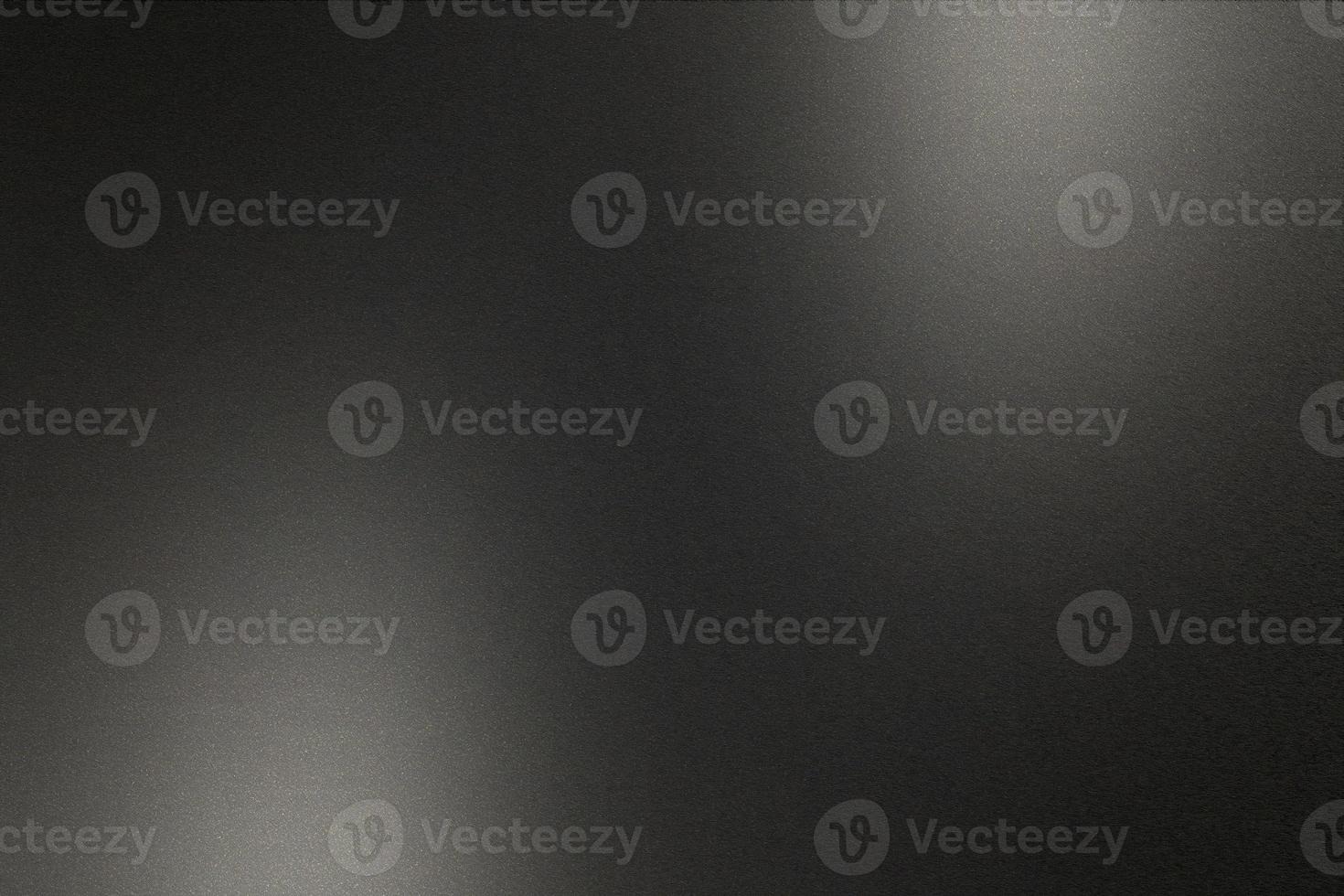 Brushed black metallic wall with scratched surface, abstract texture background photo