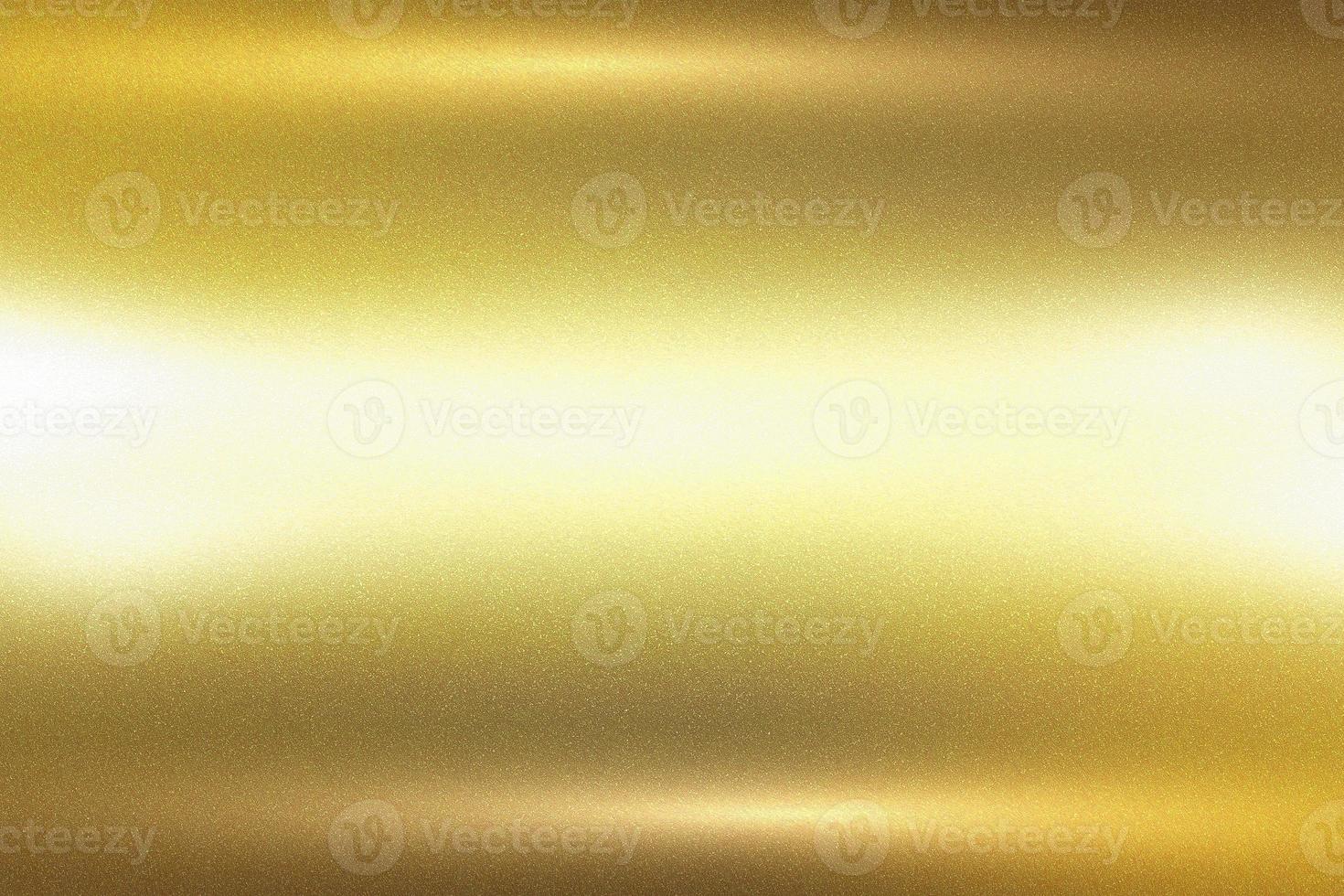 Glowing gold foil metal plate wall with copy space, abstract texture background photo