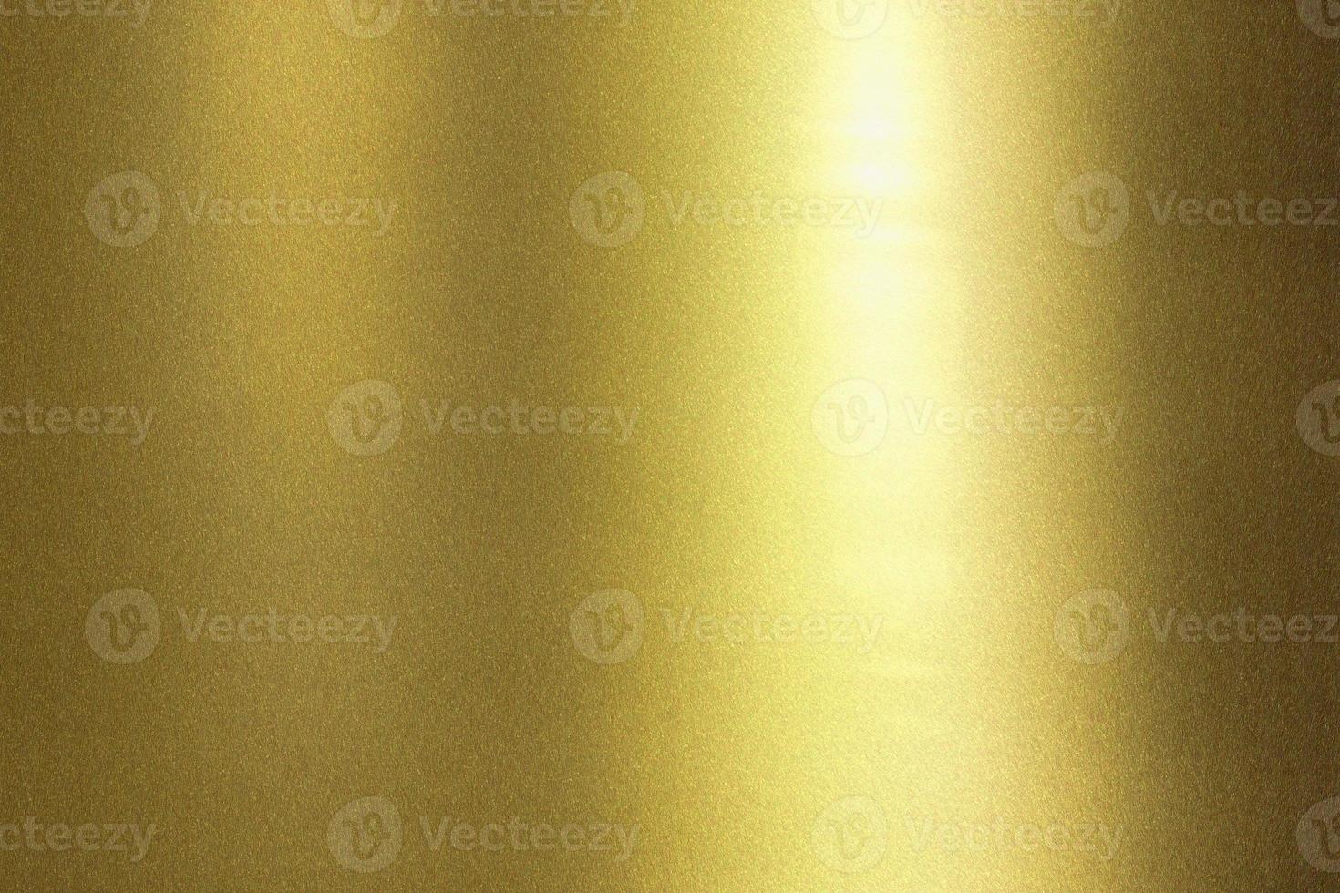 Light shining on wave golden metal wall, abstract texture background photo