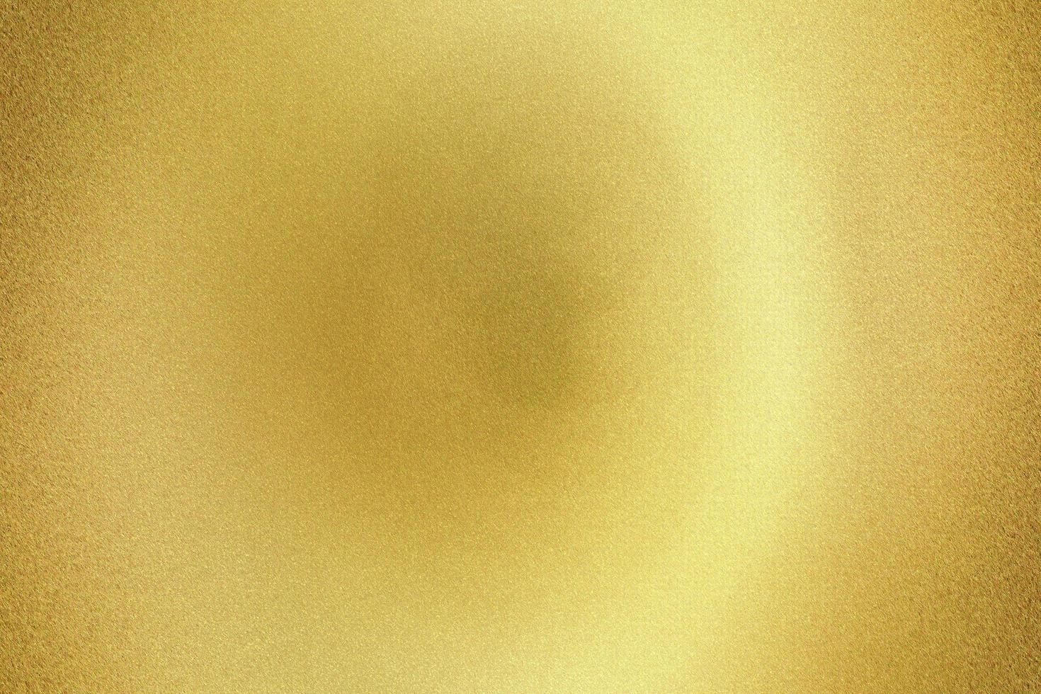 Light shining on gold rough metal sheet board , abstract texture background photo