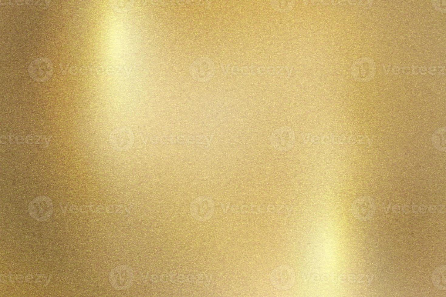 Light shining down on gold metal plate with copy space, abstract texture background photo