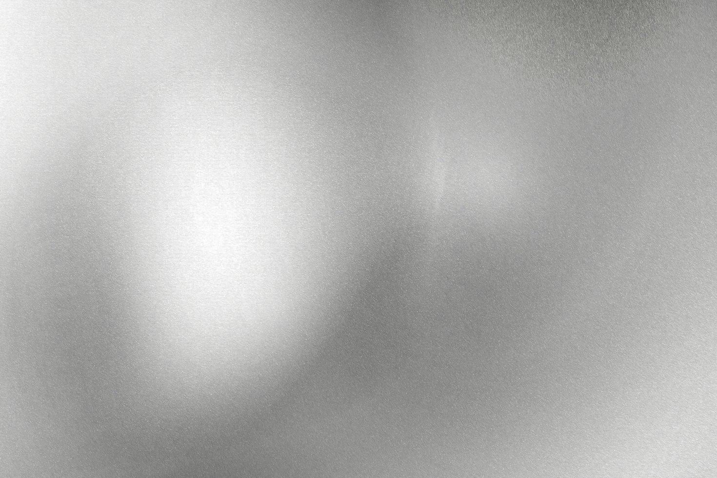 Glowing silver foil metal wall with copy space, abstract texture background photo