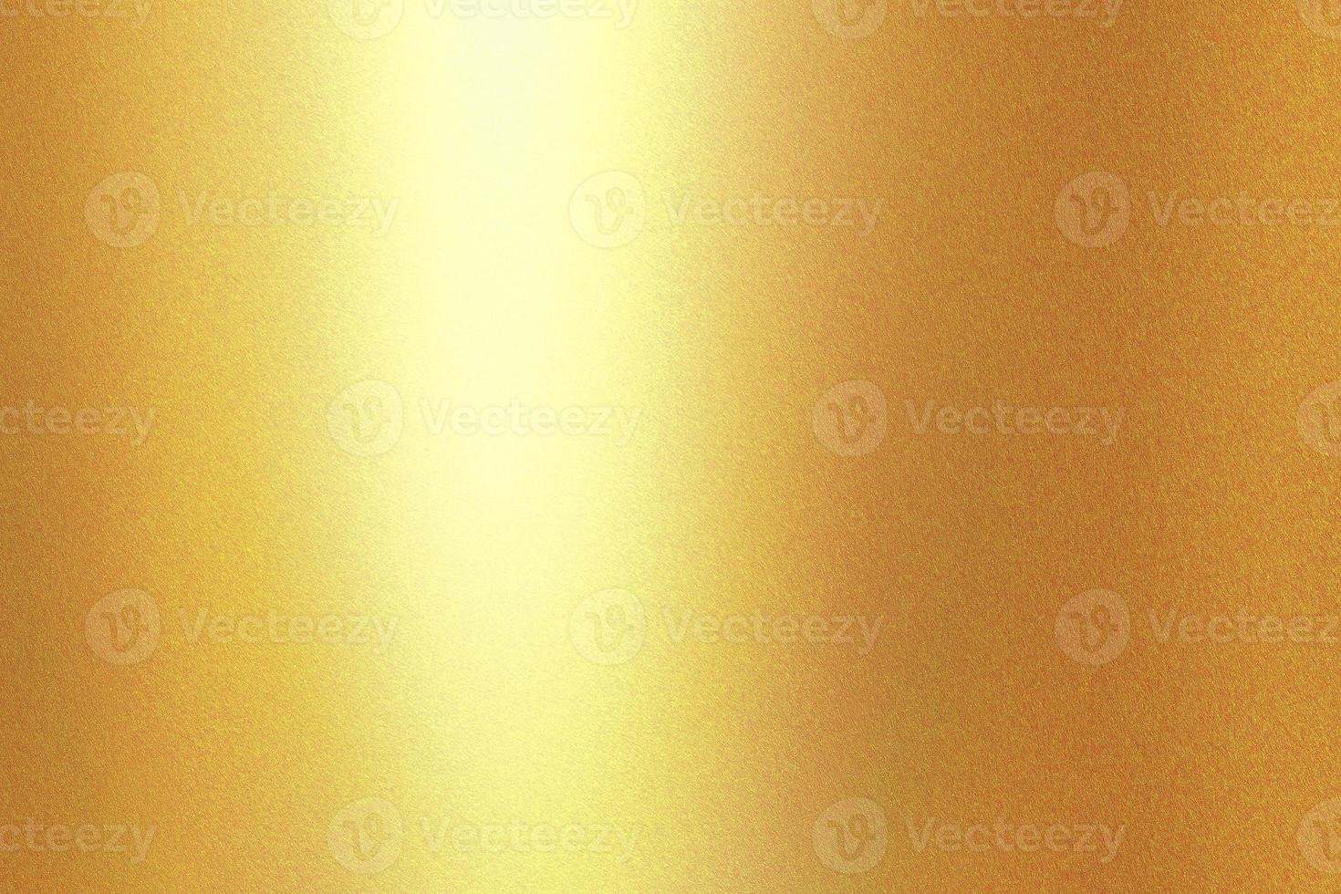 Light shining on gold painted metal wall with copy space, abstract texture background photo
