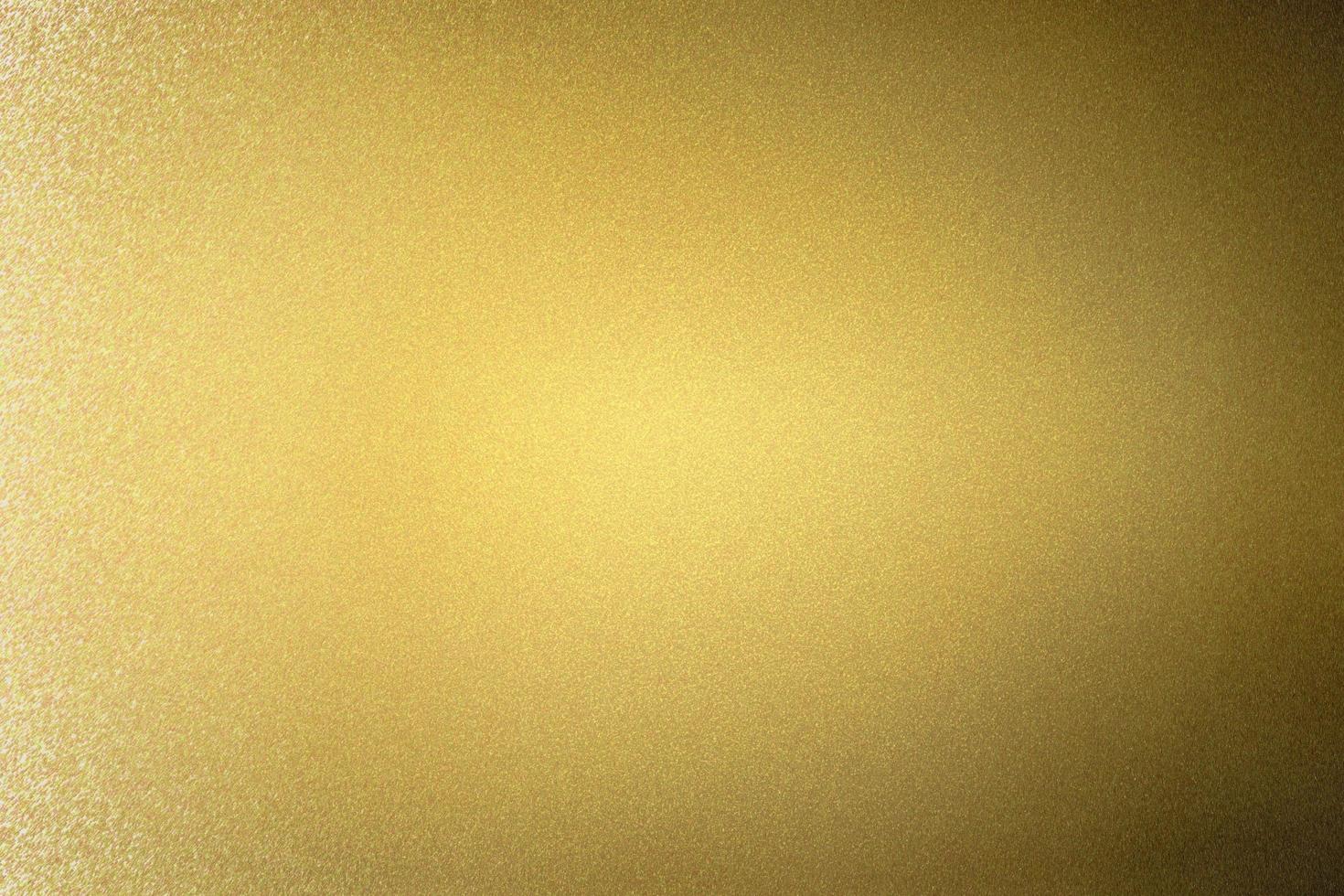 Abstract texture background, reflection brushed gold metallic wall in dark room photo