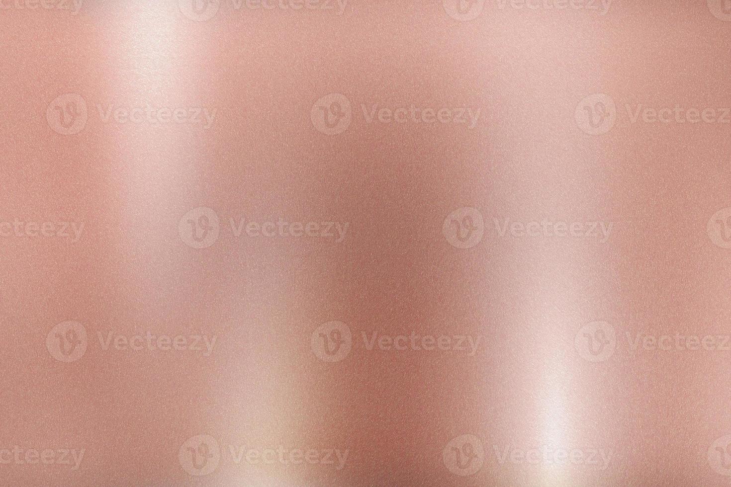 Rose gold foil metallic wall with glowing shiny light, abstract texture background photo