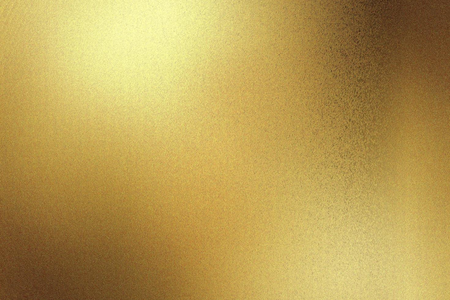 Light shining on gold painted metallic wall with copy space, abstract texture background photo