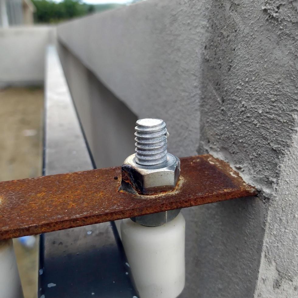 Focus on the screw nut for the construction of the fence gate of the building. photo