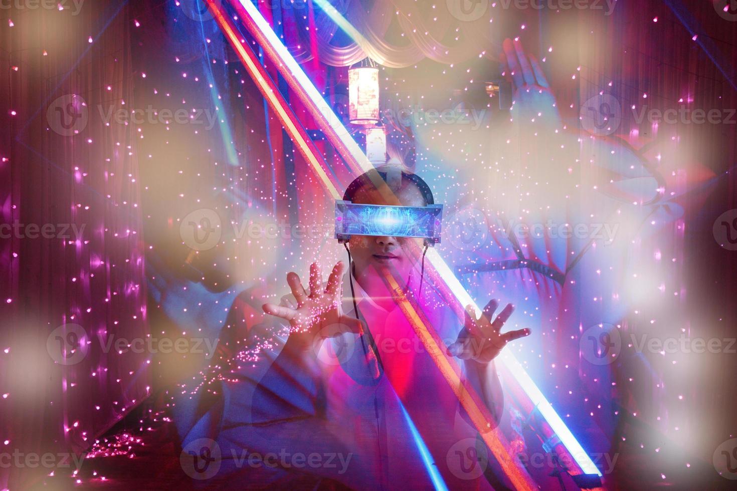 Defocus overlapping image of a man wearing virtual reality glasses and a modern building. Metaverse digital cyber technology concept. Future digital technology cyber virtual game entertainment. photo