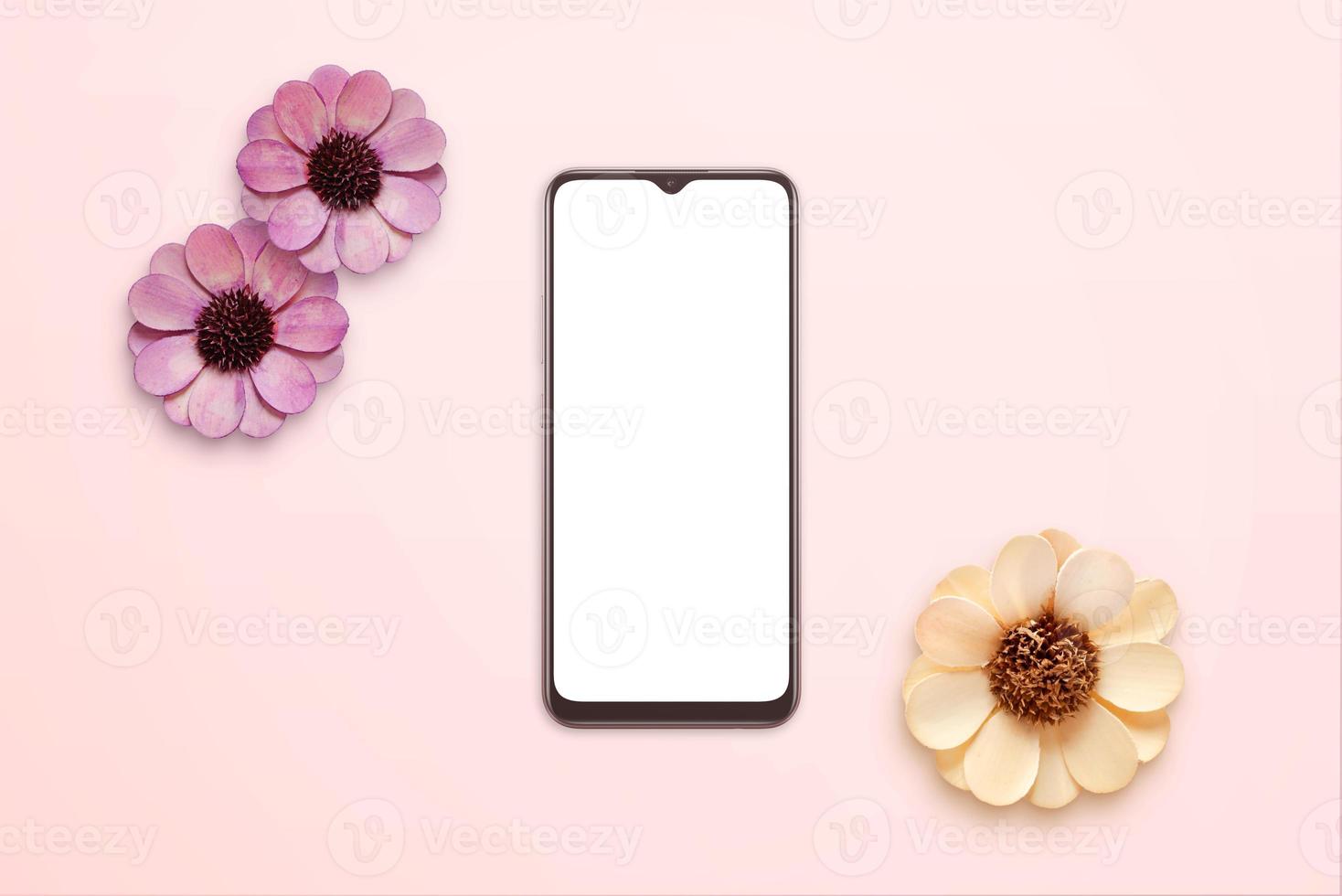 Phone mockup surrounded by sprin flowers. Top view, flat lay pastel composition photo