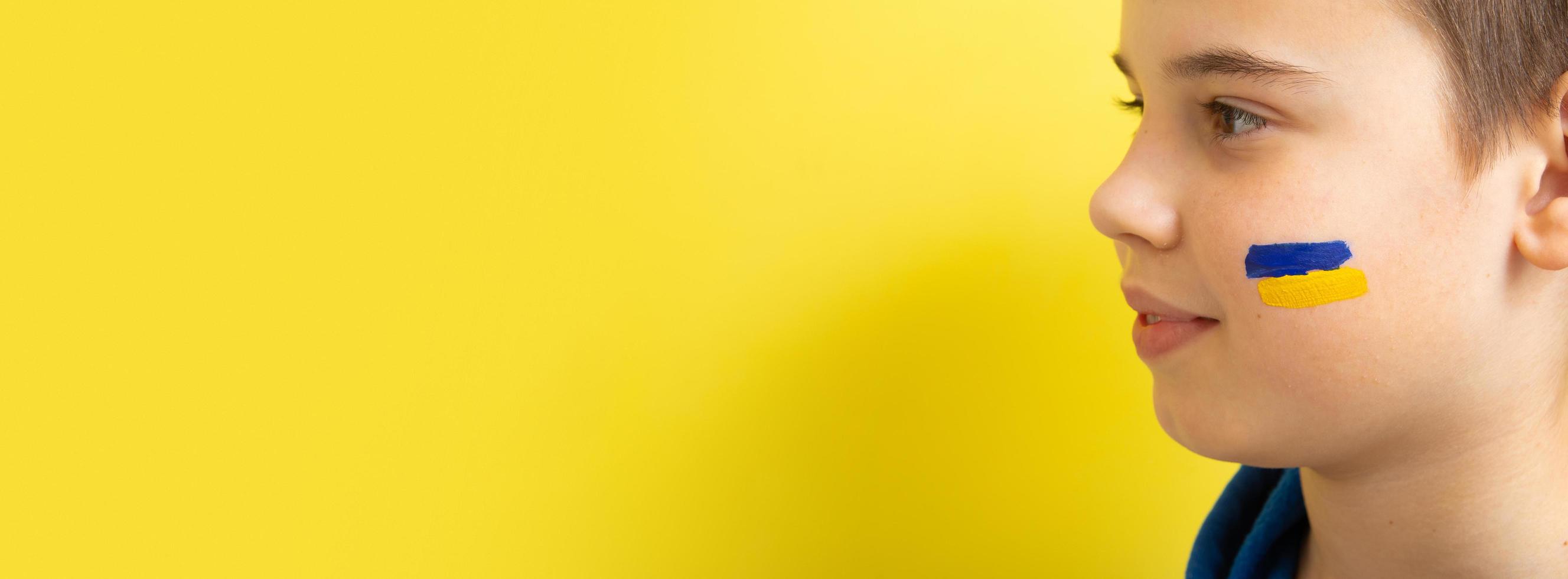 Banner with profile of a boy with yellow and blue colors of the Ukrainian flag on his cheek photo