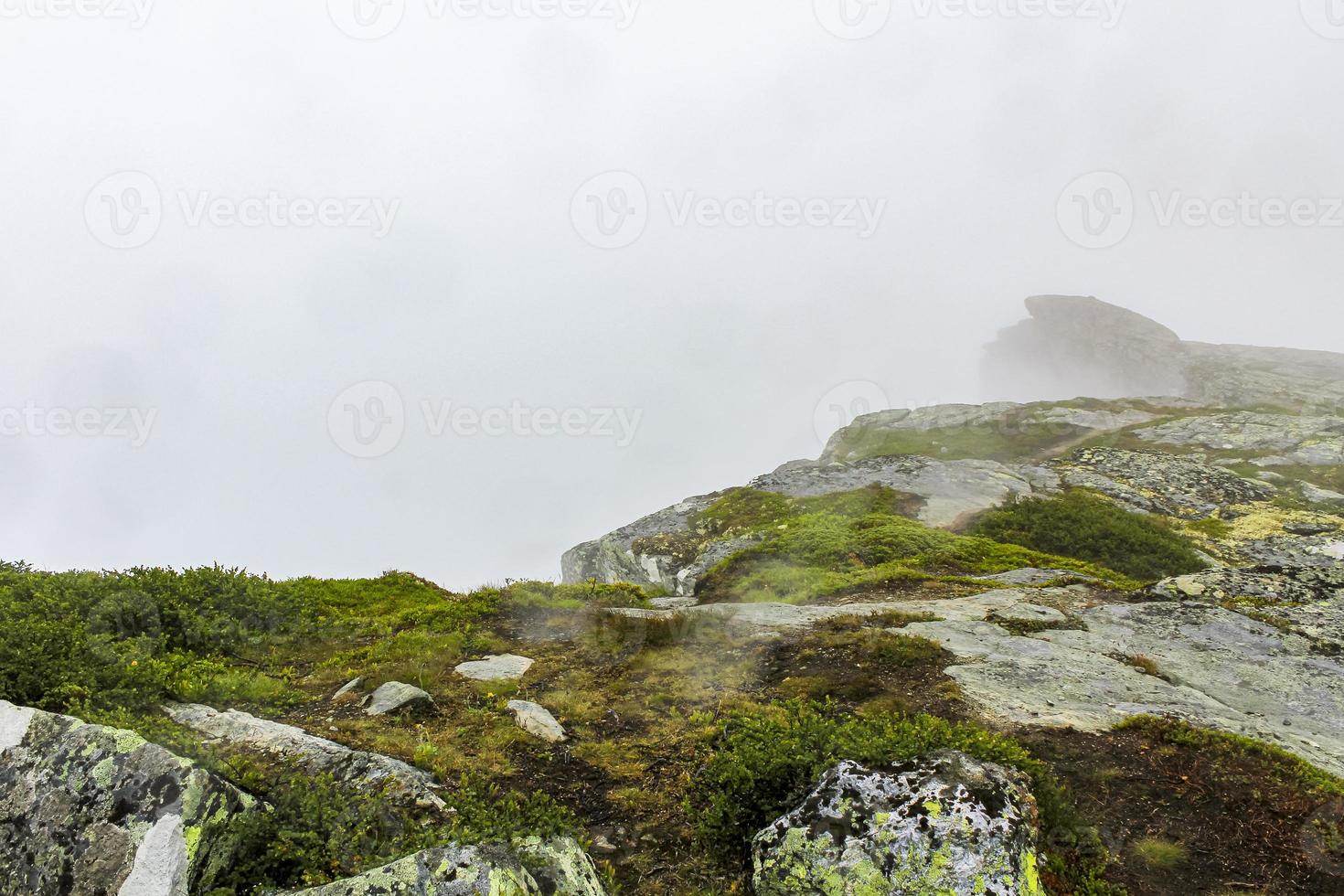 Fog, clouds, rocks and cliffs on Veslehodn Veslehorn mountain, Norway. photo