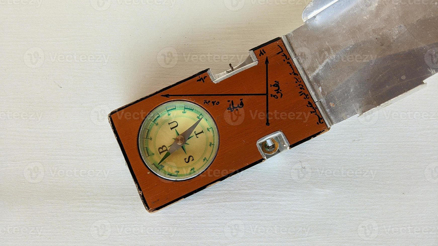 A special compass to determine the Qibla direction of the grave. photo