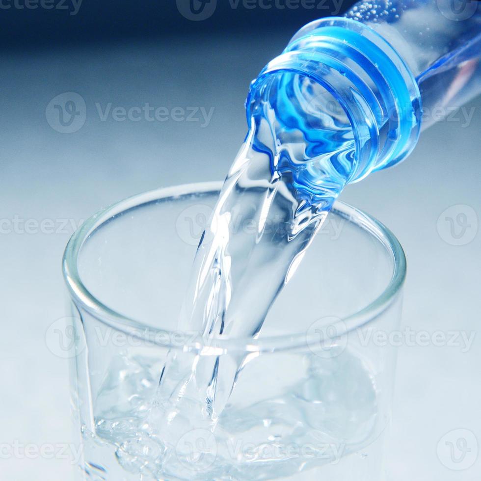 glass is filling splashing water collection on white background photo