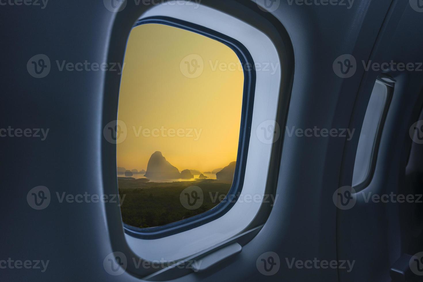 Concept image of touring and transportation, airplane's window with Samed Nang Shee ariel view in Thailand. photo