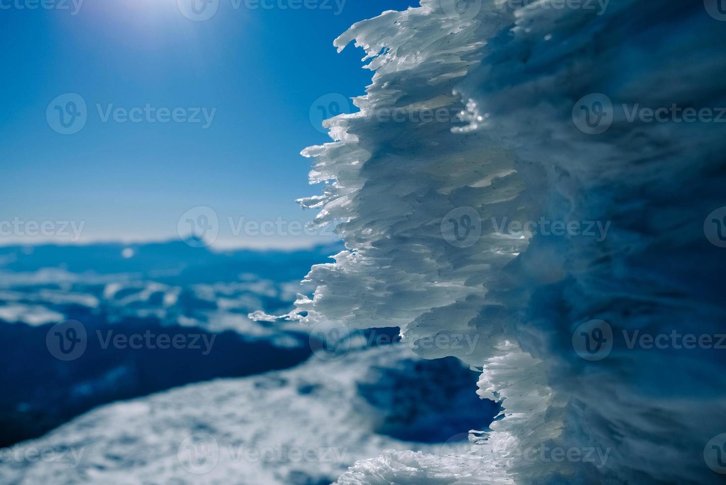 Snow-capped mountains on a background of blue sky photo