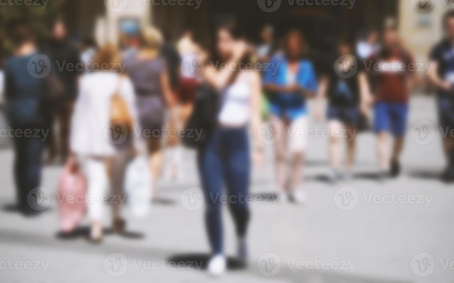 blurred city people walking on busy pedestrian shopping street photo