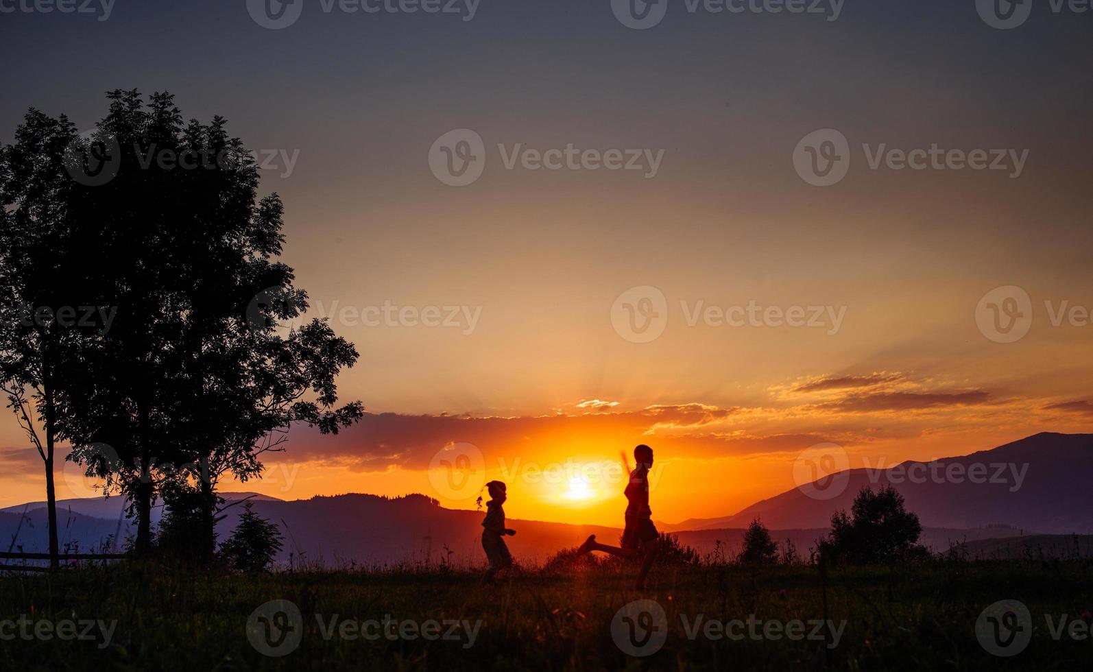 village silhouette at sunset photo