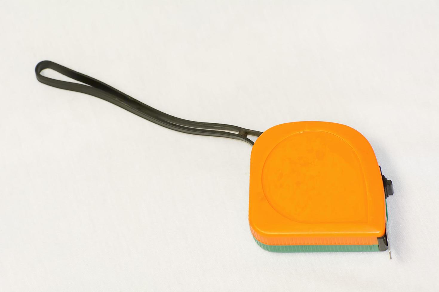 Orange measuring tape on white background. photo