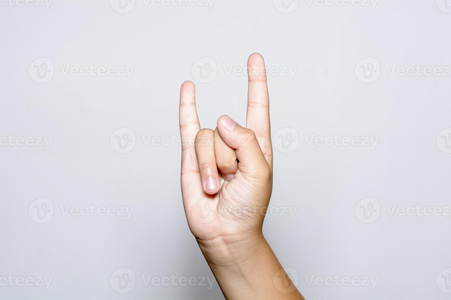 Boy hand show the Rock and Roll sign photo