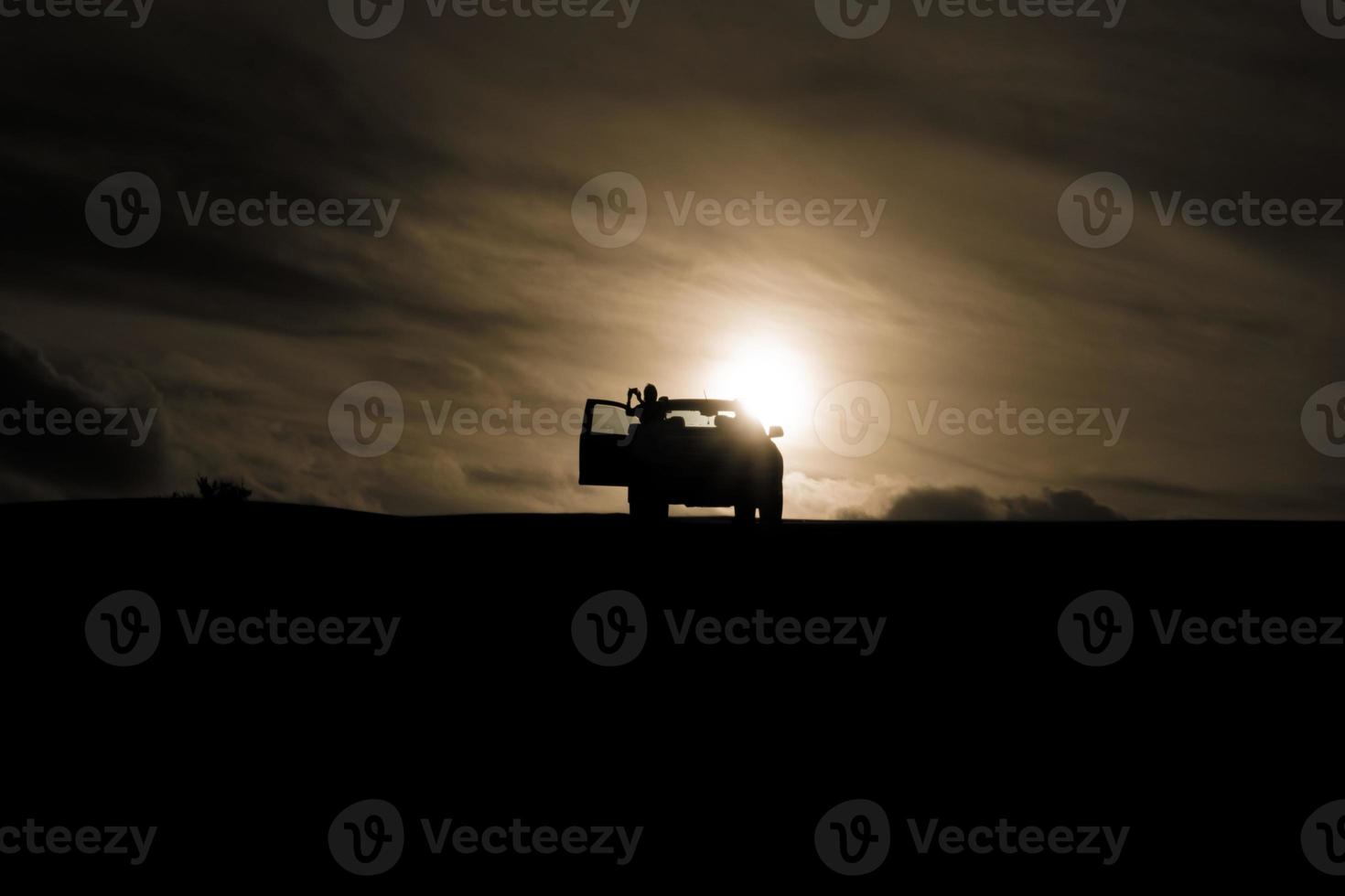 Sunset behind a car photo