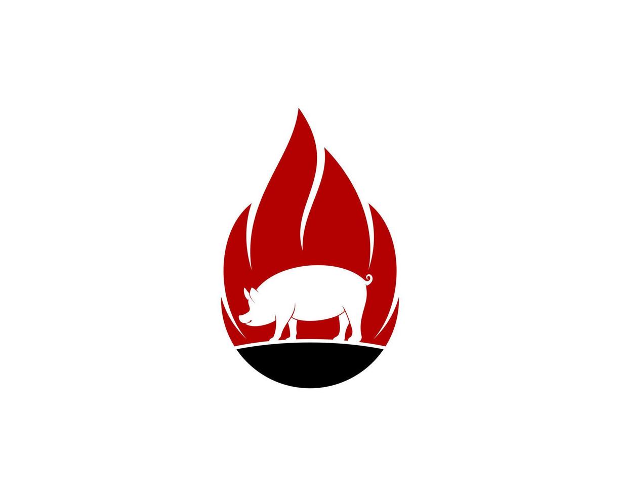 Standing pig silhouette with fire flame behind vector