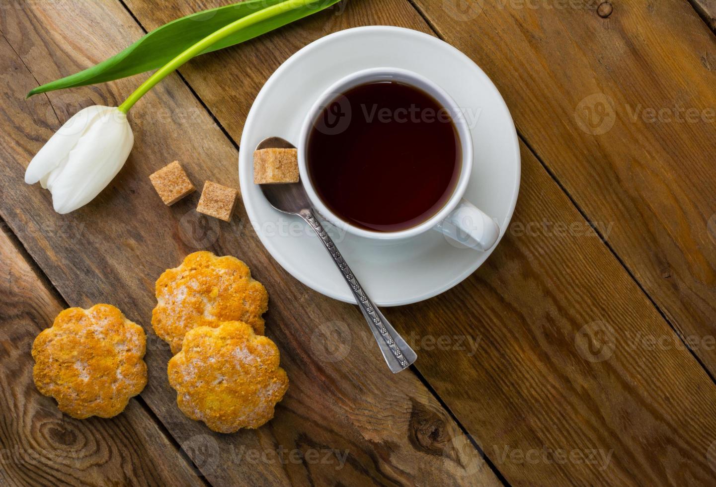 Cup of tea and crumbly homemade cookies top view photo