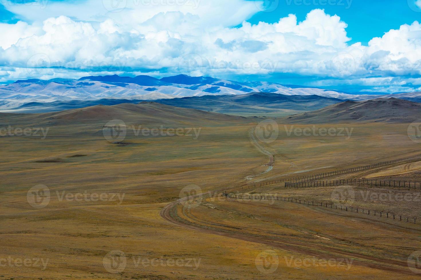 Road stretches into the distance across the steppe photo