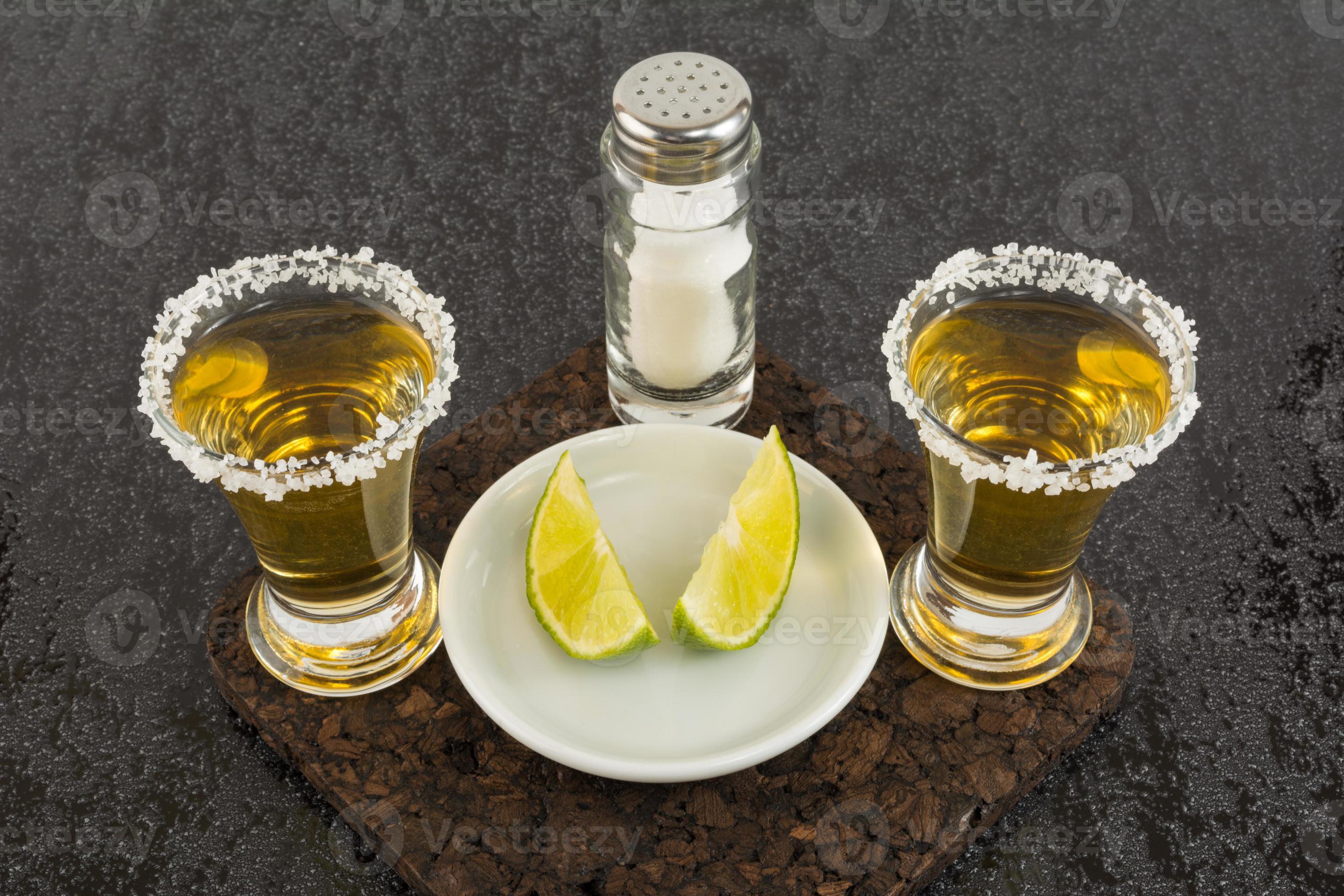 Two shots of gold tequila 6962200 Stock Photo at Vecteezy