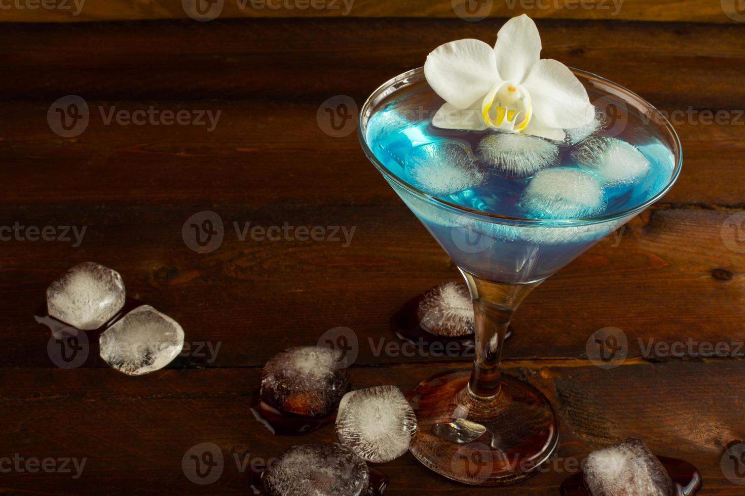 Cocktail Blue Martini on the dark wooden background photo