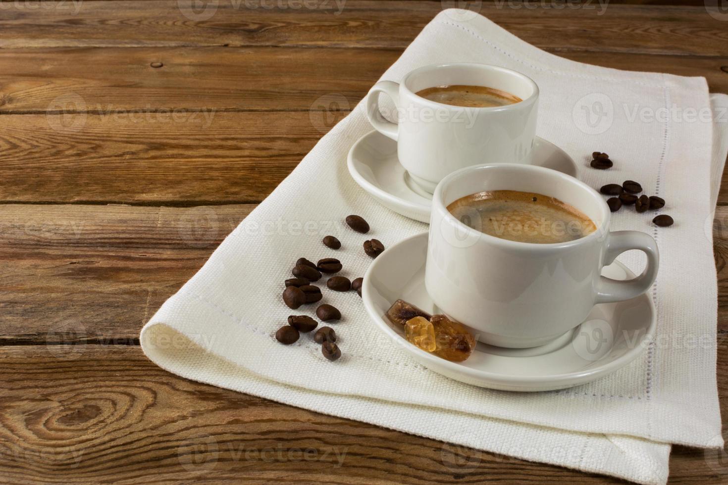 Coffee mugs on linen napkin photo