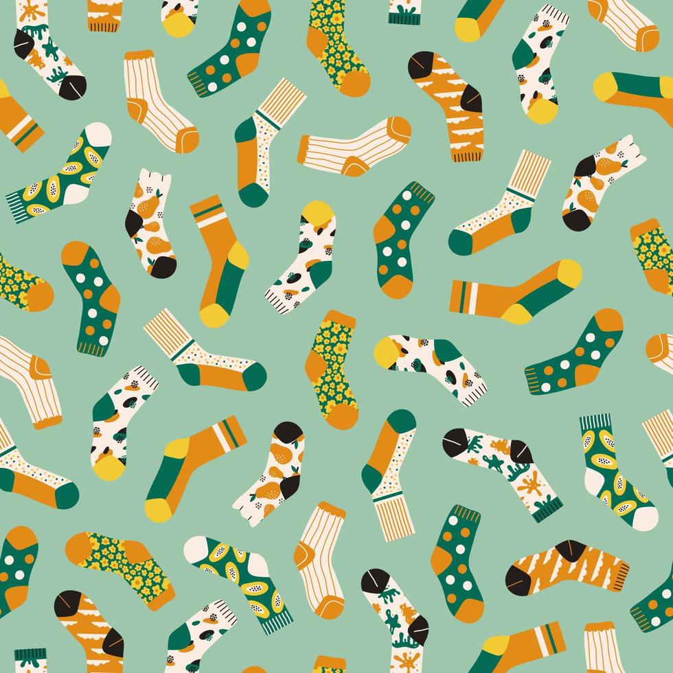 Trendy seamless pattern of colored bright socks isolated on green background. Socks with different abstract patterns. Vector cartoon illustration