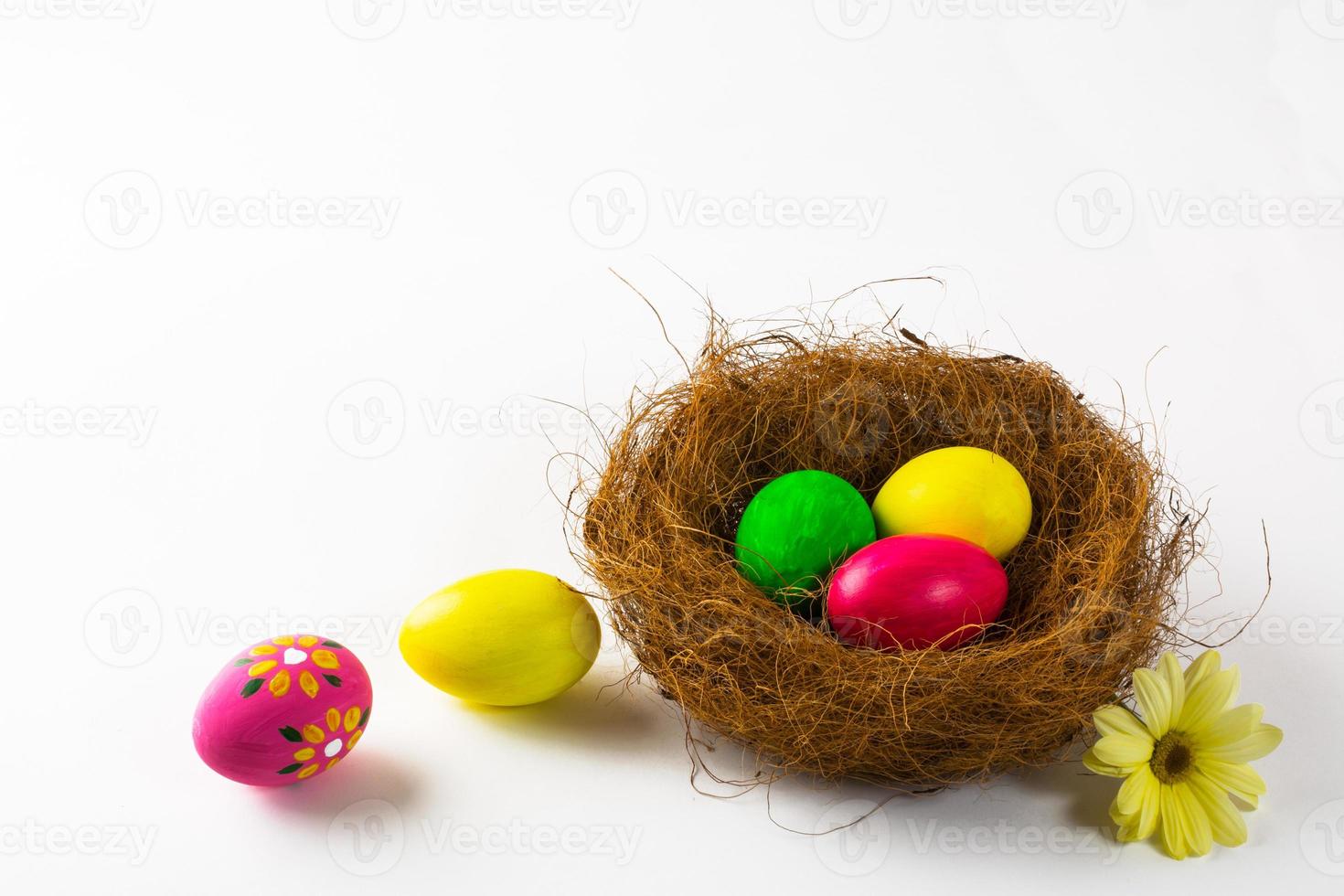 Multicolored Easter eggs in a nest photo