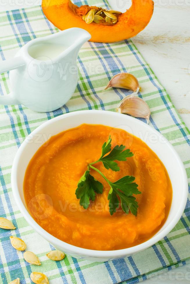 Pumpkin creamy soup with parsley photo