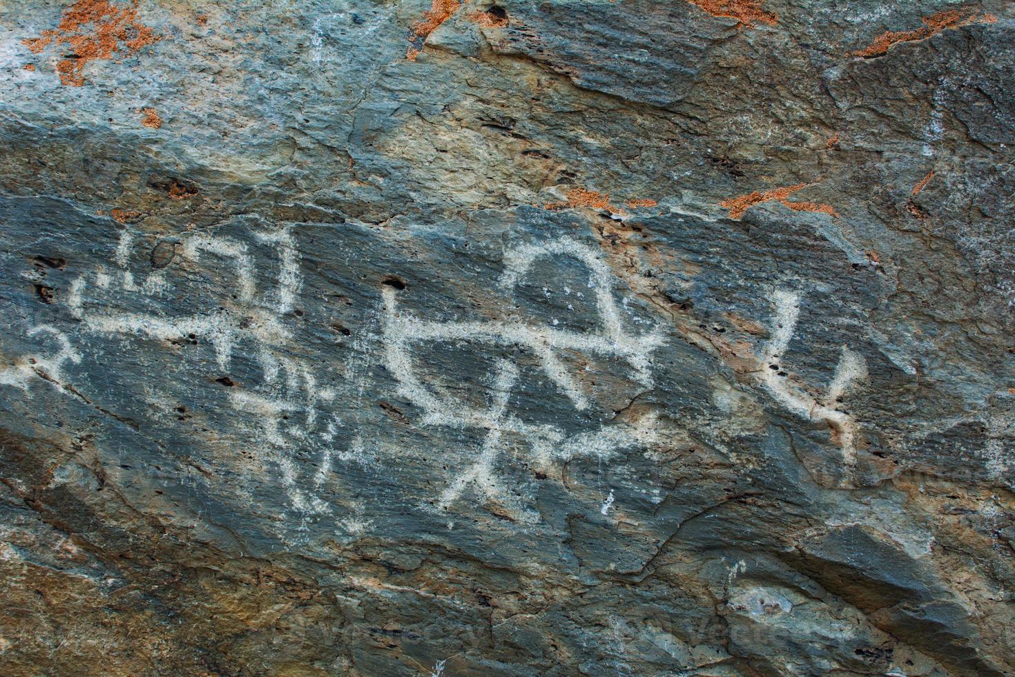 Palaeolithic Petroglyphs carved in rocks photo