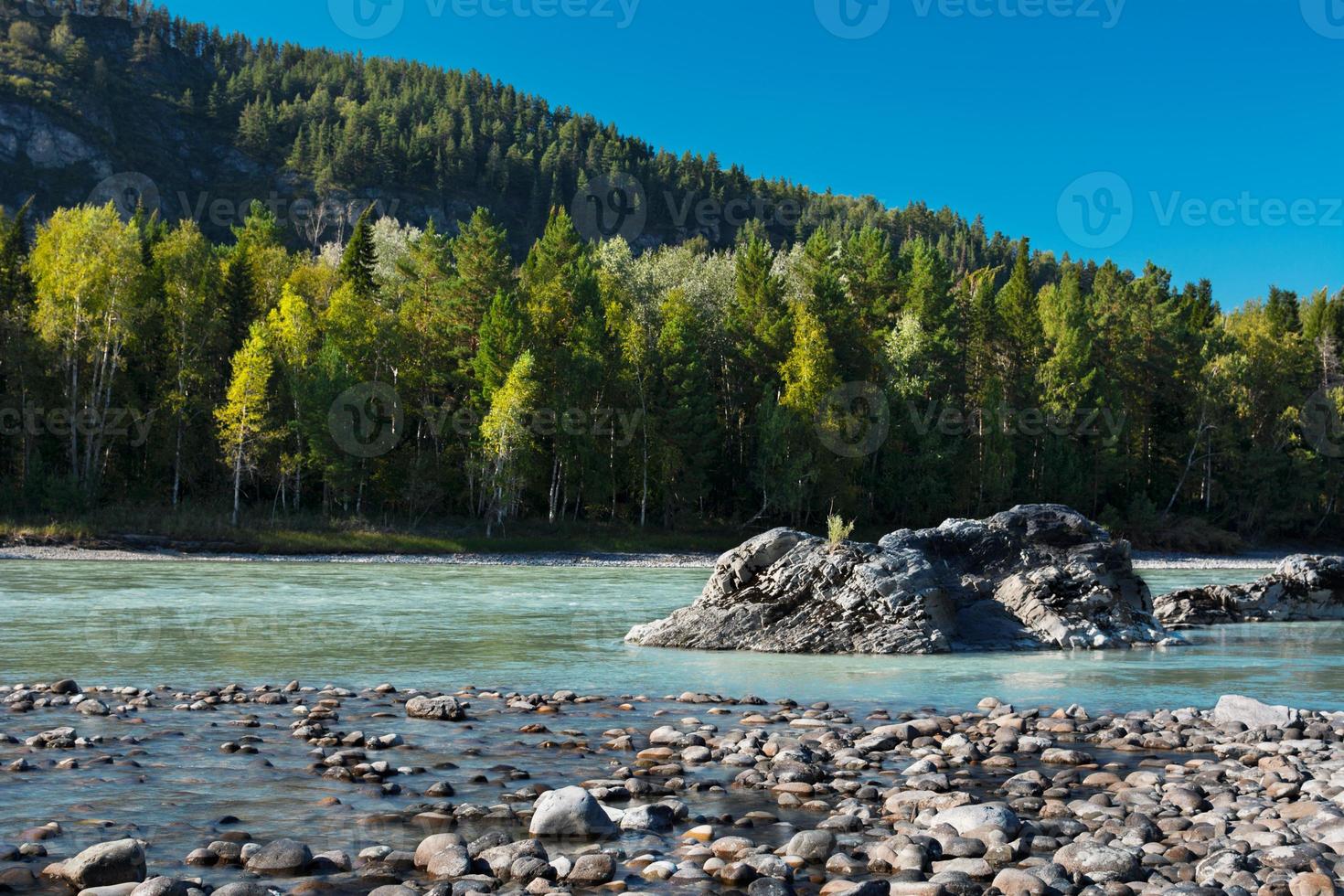 Rocky shore of the turquoise river photo