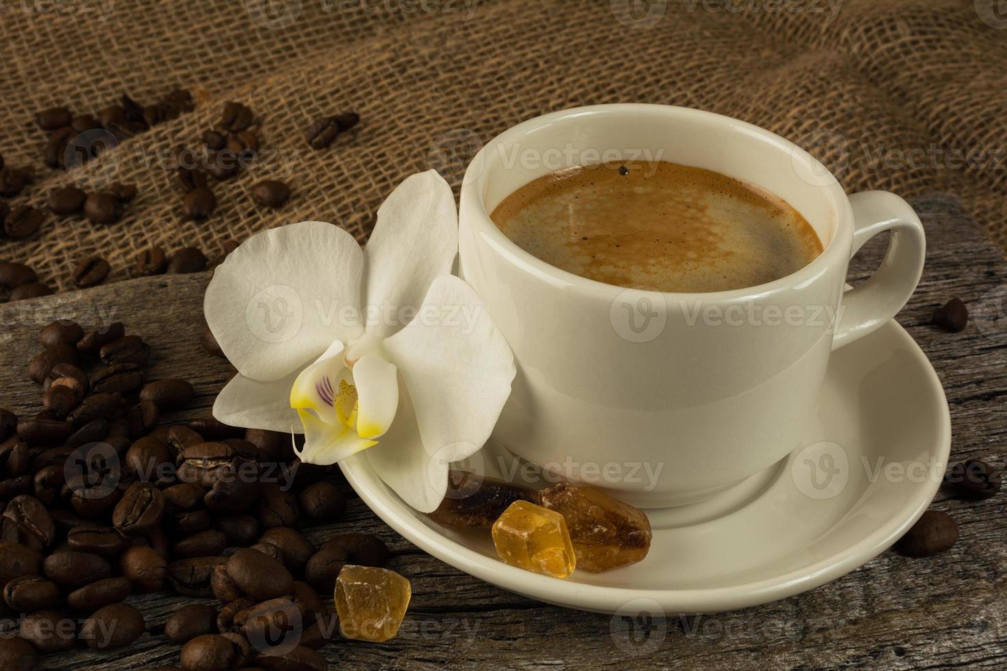 White cup of strong morning coffee and coffee beans photo