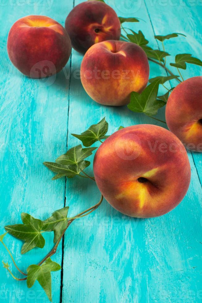 Peaches on turquoise table photo