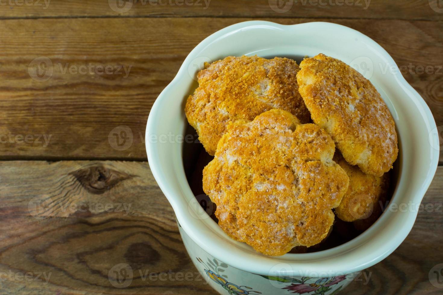 Cookies in a jar on rustic wooden background photo