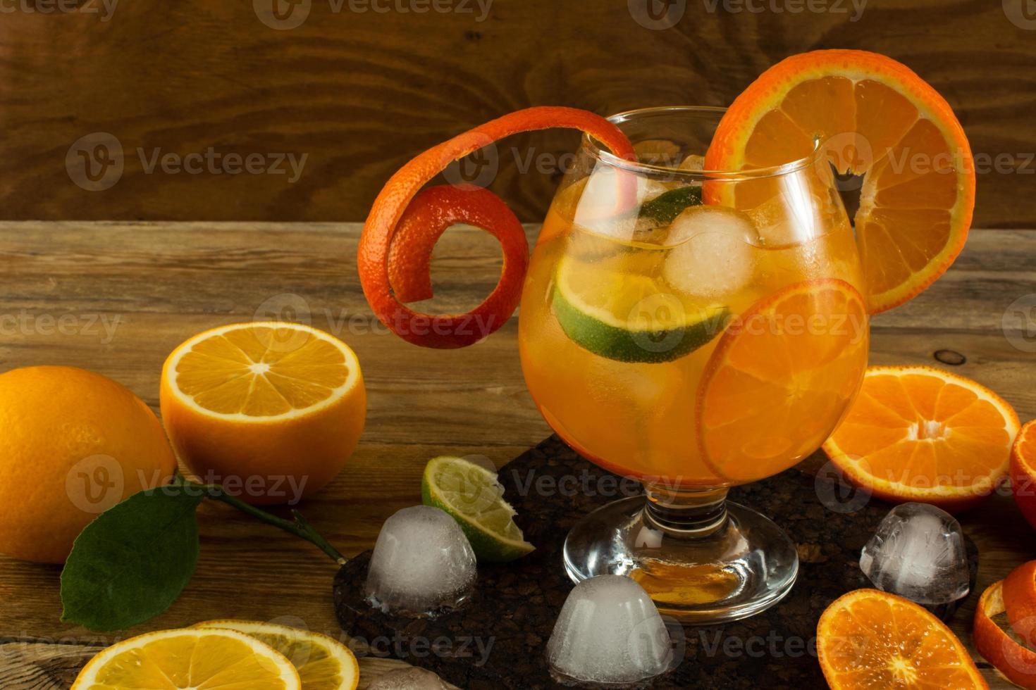 Pitcher of cool lemonade on wooden table photo